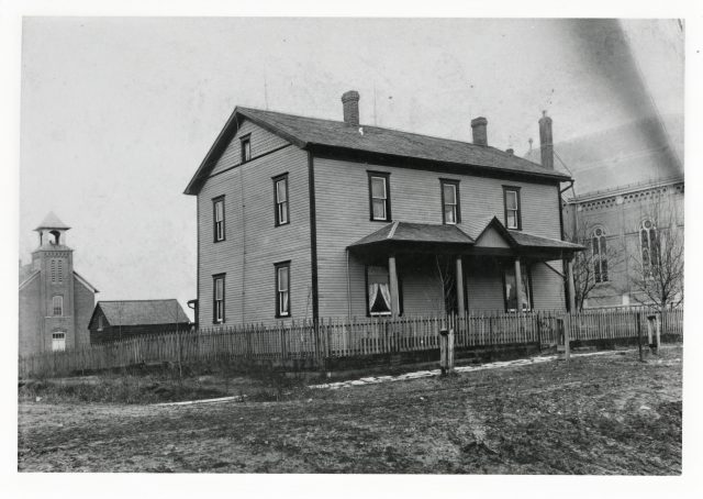 Photo caption - Alfrida (Kleinhenz) Willke writes in 1977: Charles Eifert residence about 1915. Maria Stein, Ohio. The school in the back is where Edgar Willke received his first three years of schooling. The next five years he went to the boys school. Now house belongs to Lee Eifert. (Note: St. John the Baptist Church is to the right of the photo.)

My grandmother, Alfrida (Kleinhenz) Willke wrote: At the age of five years Edgar Willke started school, which was located northwest of St. John Church. He attended school in this building for three years, which had one classroom for boys and girls, and taught by a nun. It was located on the first floor. The next five years he went to an all-boys school which was located east of the church. It was a one-room school taught by a man. The classroom for the five upper grades for girls was located on the second floor of the school located northwest of the church.